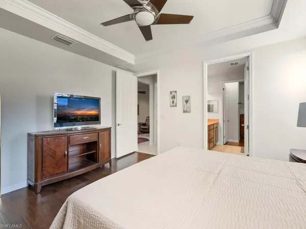 a bedroom with furniture and a flat screen tv