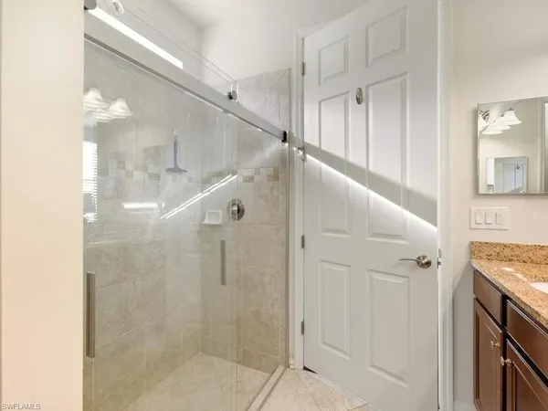 a view of entryway with bathroom and shower