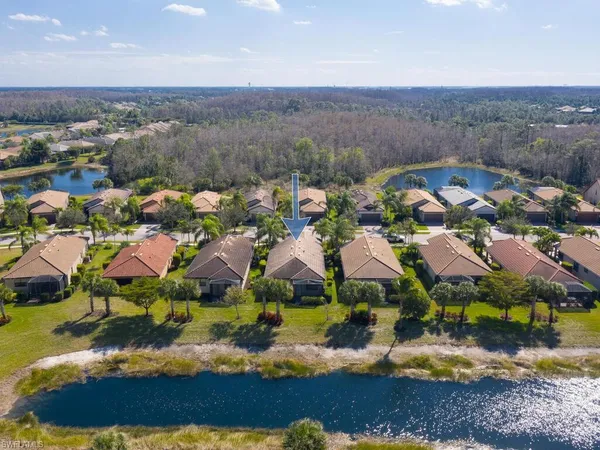 an aerial view of residential houses with outdoor space and river