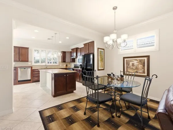 a view of a dining room with furniture and a chandelier
