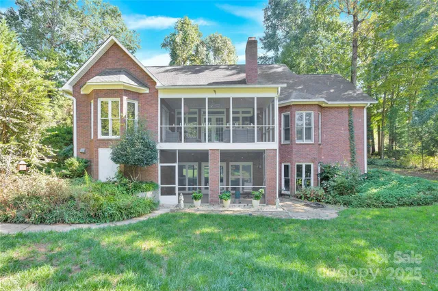 a front view of a house with yard and glass windows