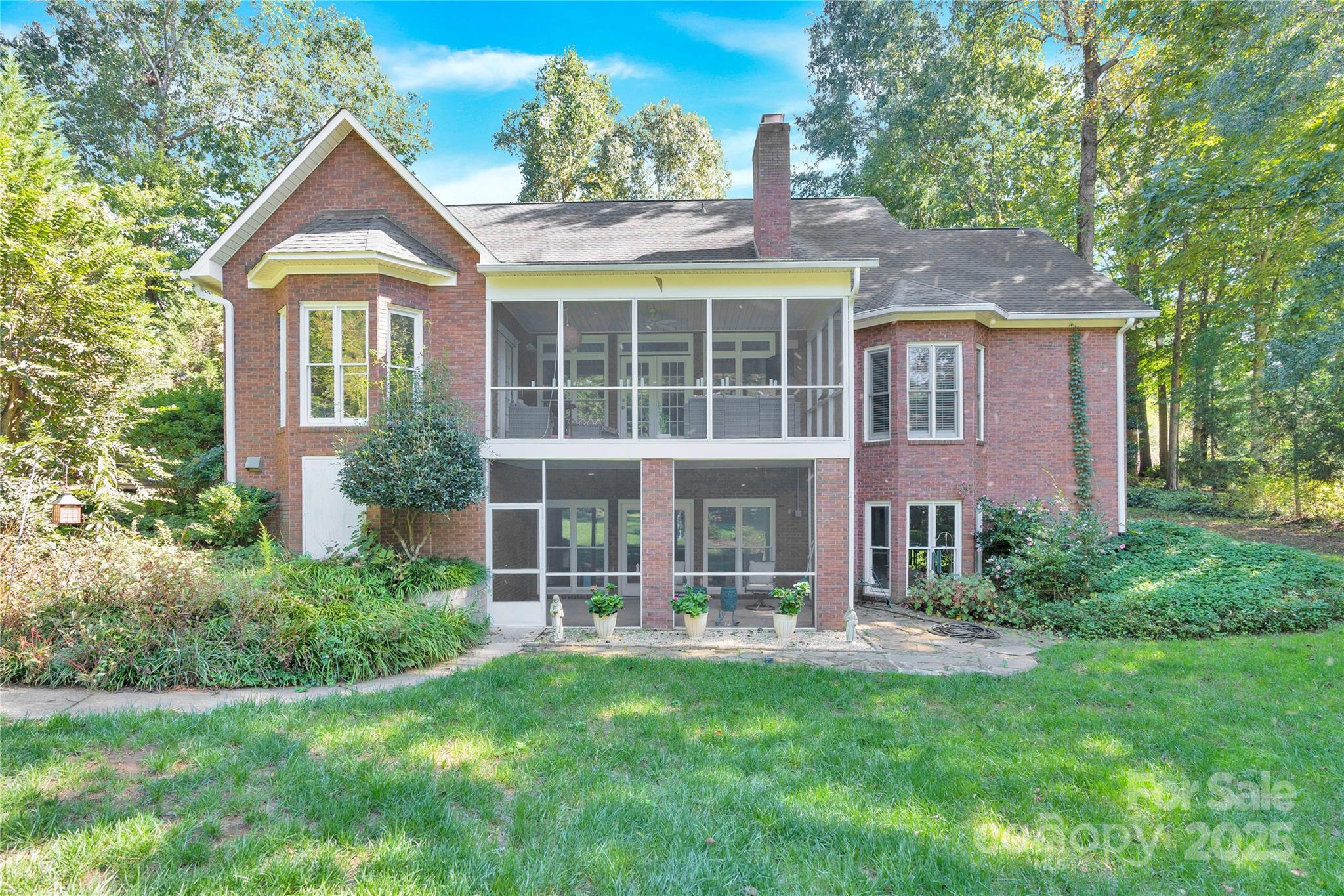 a front view of a house with yard and glass windows