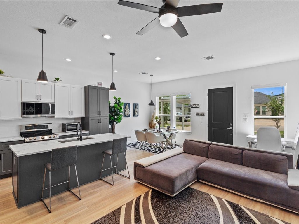 a living room with furniture and a wooden floor