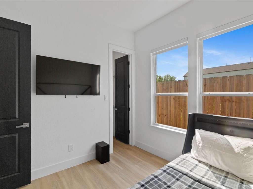 3549 Amos Street Houston, TX 77021 - Photo 11 of 25 a bedroom with a bed and a flat tv screen next to a window