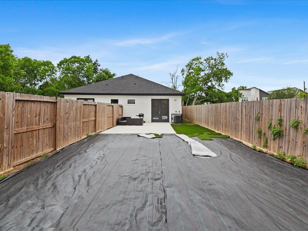3549 Amos Street Houston, TX 77021 - Photo 19 of 25 a view of a backyard with a small cabin and wooden fence