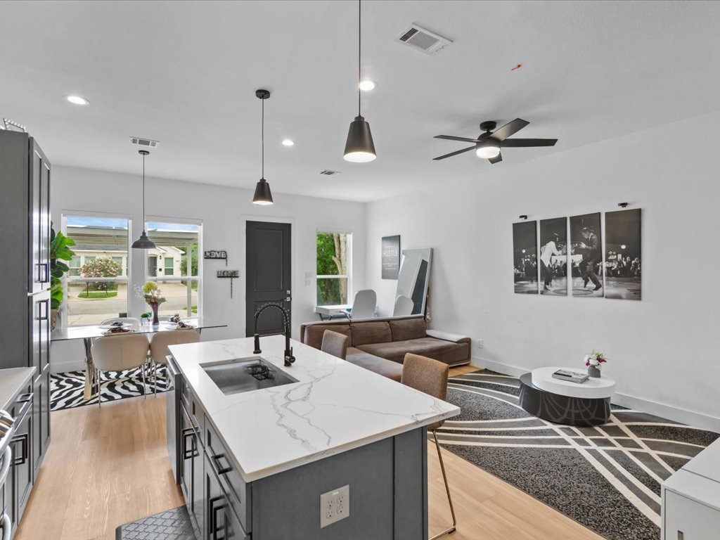 3549 Amos Street Houston, TX 77021 - Photo 4 of 25 a kitchen with a sink a counter top space and living room view