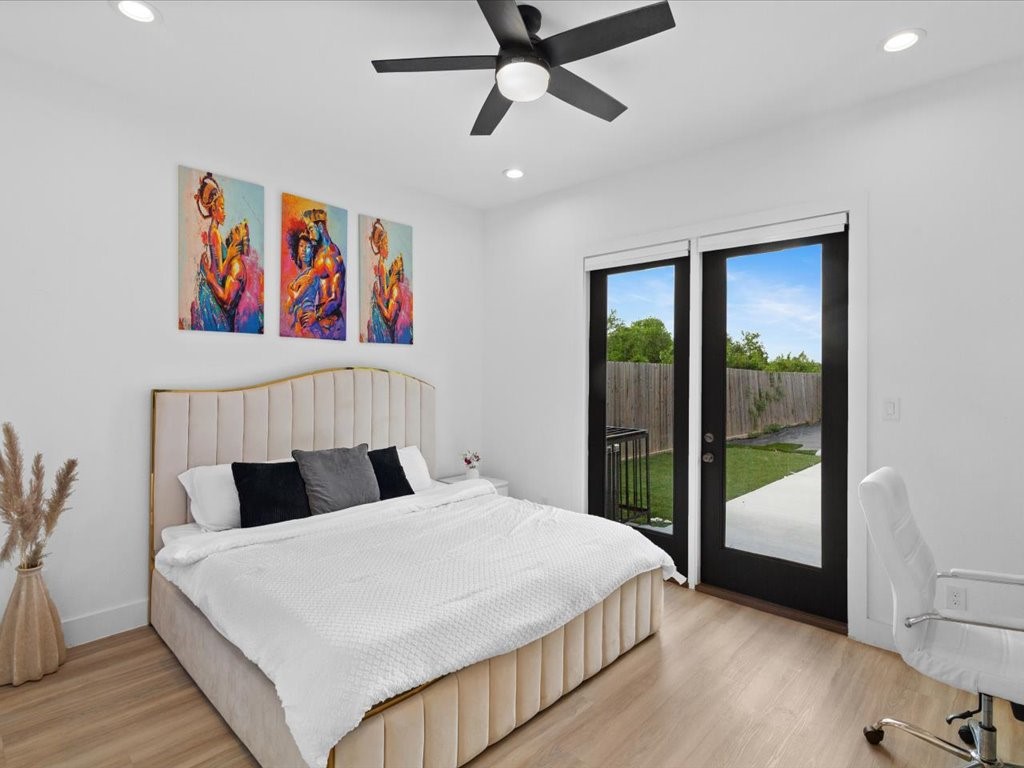 3549 Amos Street Houston, TX 77021 - Photo 5 of 25 a bedroom with a bed and wooden floor