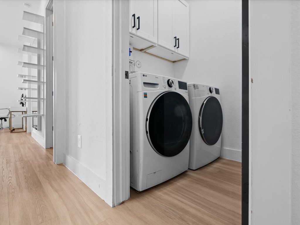 3549 Amos Street Houston, TX 77021 - Photo 9 of 25 a utility room with wooden floor washer and dryer