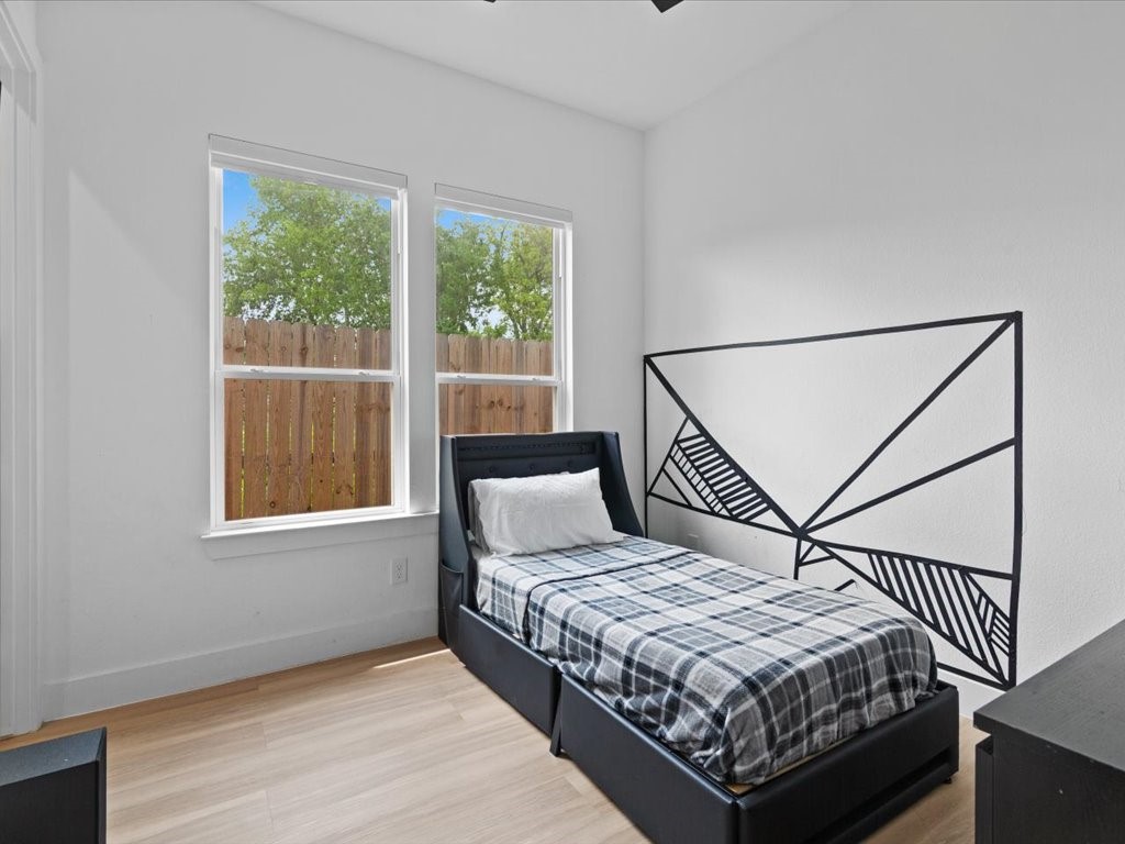 3549 Amos Street Houston, TX 77021 - Photo 10 of 25 a bedroom with a bed and wooden floor