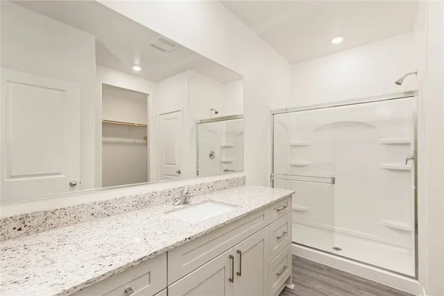 a bathroom with a granite countertop sink mirror toilet and bathtub