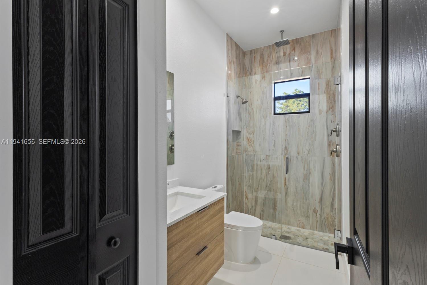 1236 East County Lehigh Acres, FL 33974 - Photo 22 of 44 a bathroom with a granite countertop sink toilet and shower