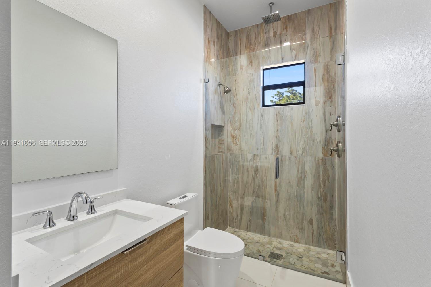 1236 East County Lehigh Acres, FL 33974 - Photo 23 of 44 a bathroom with a sink a toilet and shower