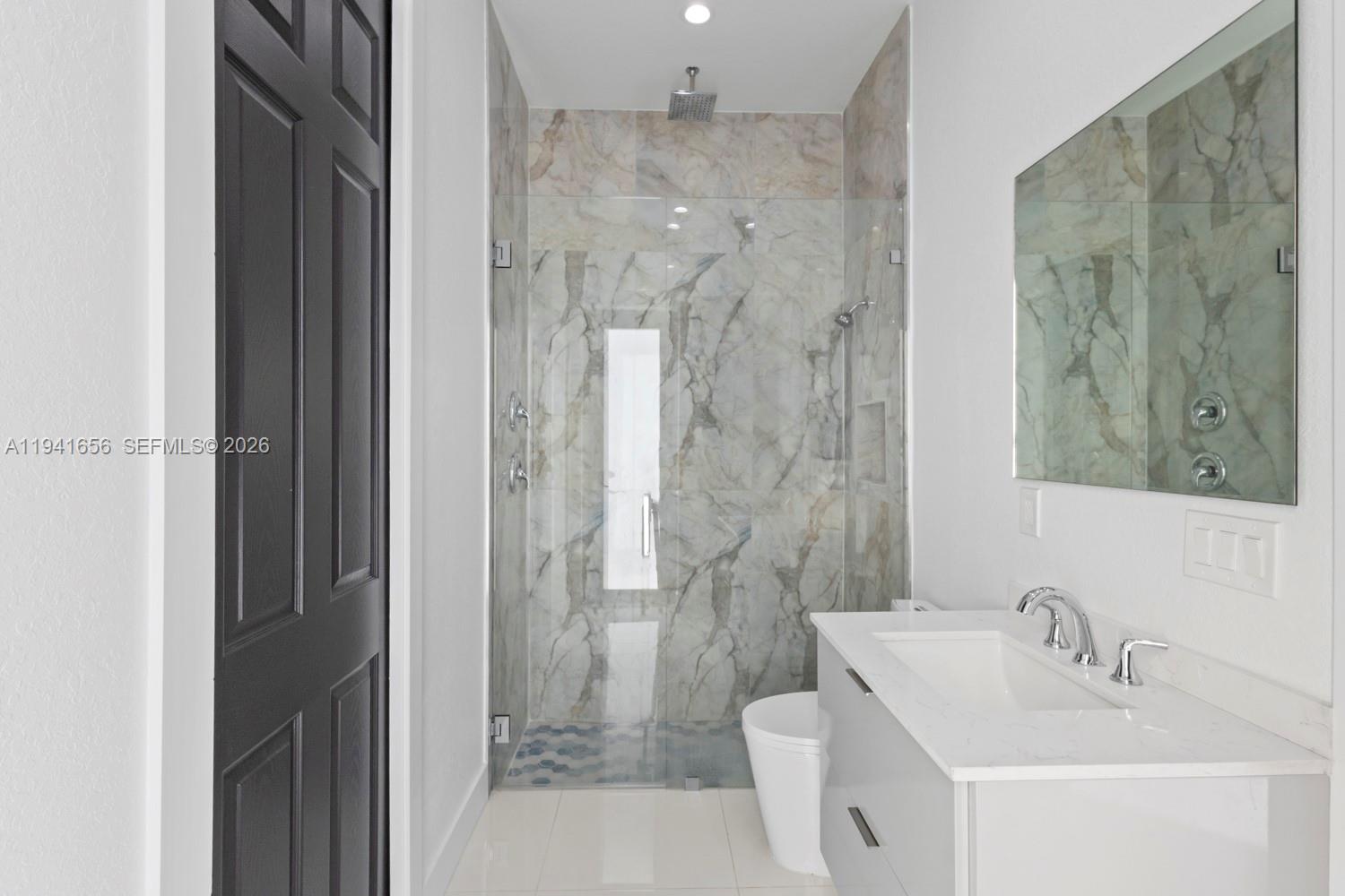 1236 East County Lehigh Acres, FL 33974 - Photo 27 of 44 a bathroom with a sink and a mirror