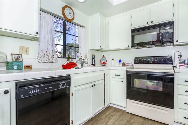 a kitchen with stainless steel appliances a stove a microwave and cabinets
