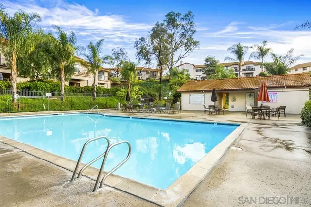 a view of swimming pool with outdoor seating and yard