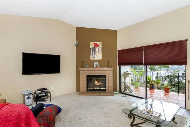 a living room with furniture tv and a fireplace