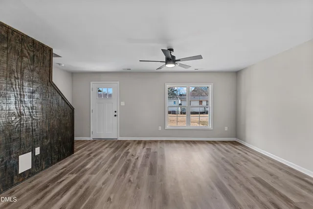 a view of a livingroom with a ceiling fan and window