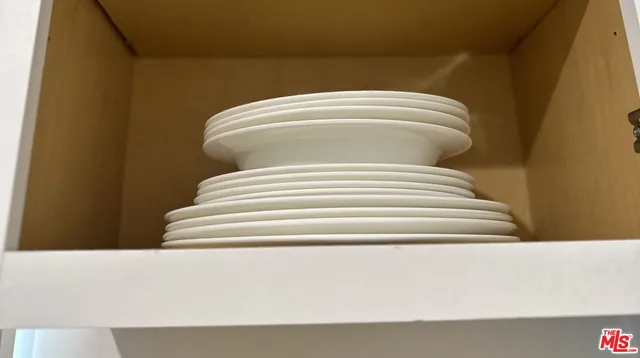 a bedroom with a bed and cabinets