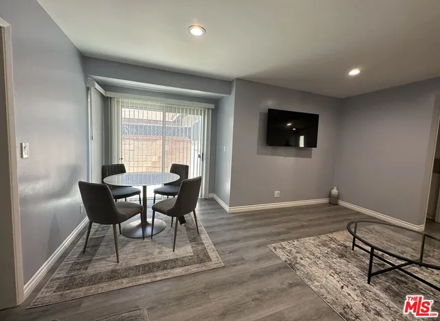 a view of a livingroom with furniture and a window