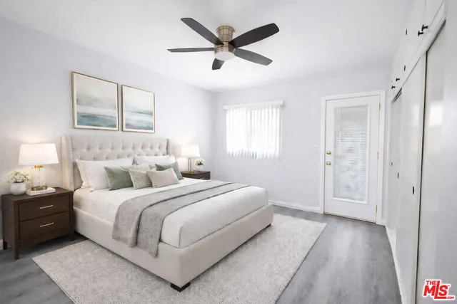 a spacious bedroom with a bed and a chandelier