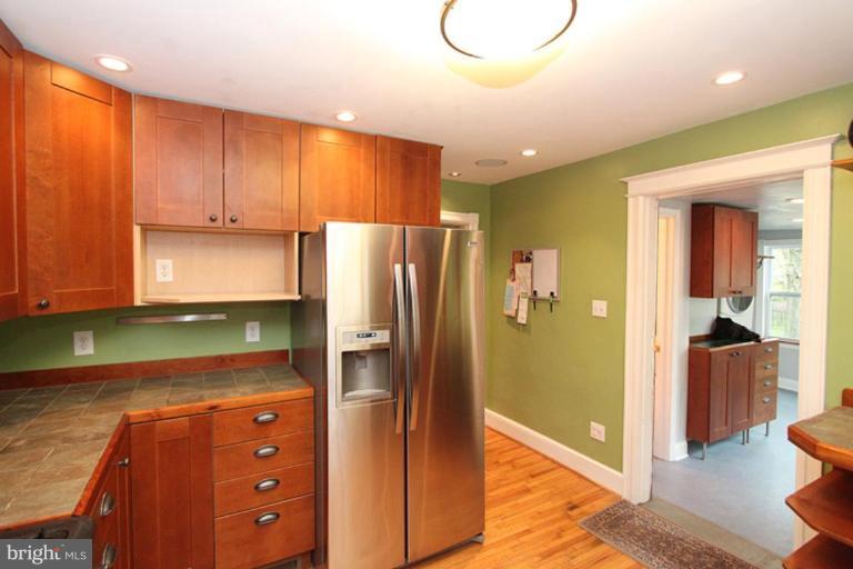 140 Ritchie Avenue Silver Spring, MD 20912 - Photo 14 of 23 a kitchen with a refrigerator and a stove top oven