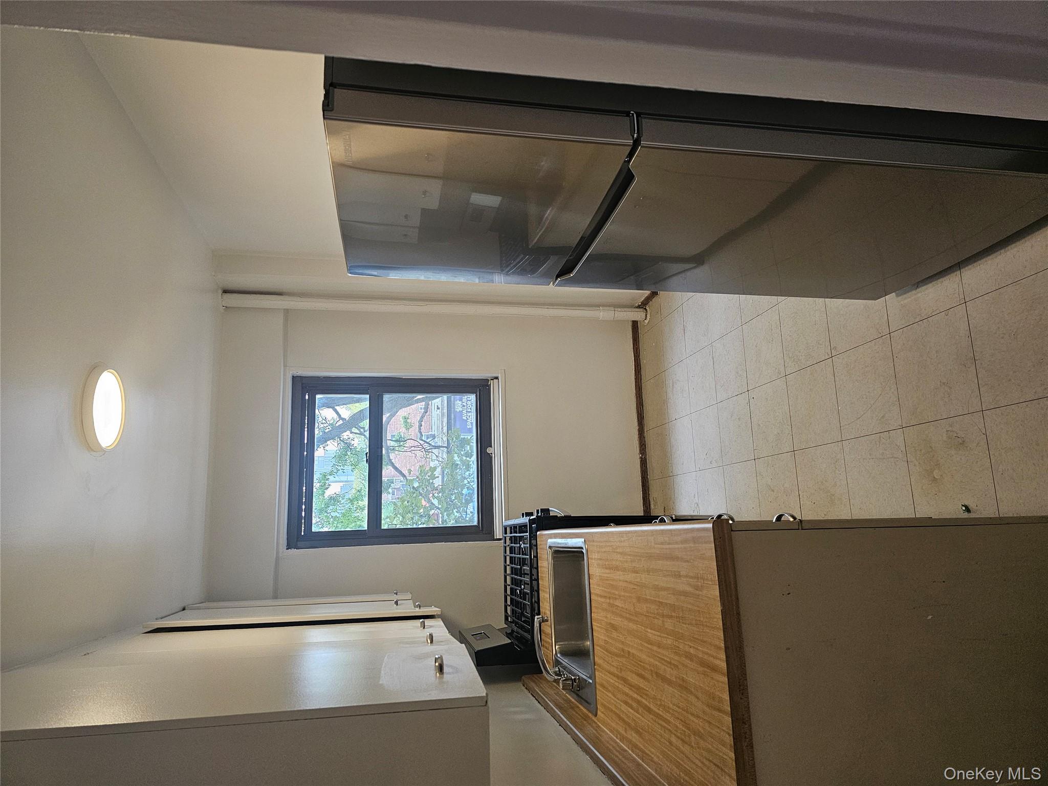 21-85 34th Avenue, Unit 3B Queens, NY 11106 - Photo 12 of 12 a kitchen with a refrigerator and a stove