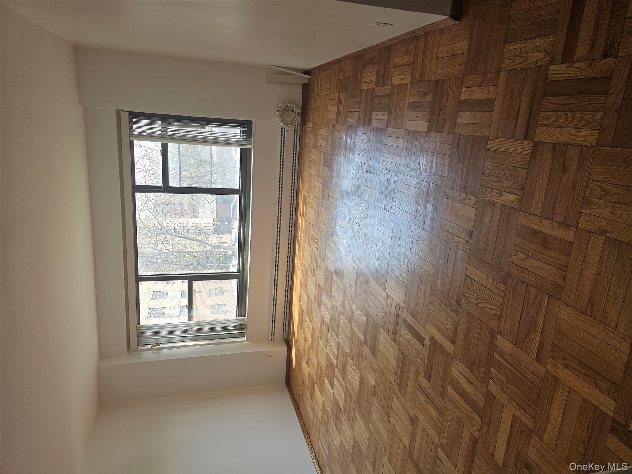 21-85 34th Avenue, Unit 3B Queens, NY 11106 - Photo 2 of 12 a view of an empty room with a window