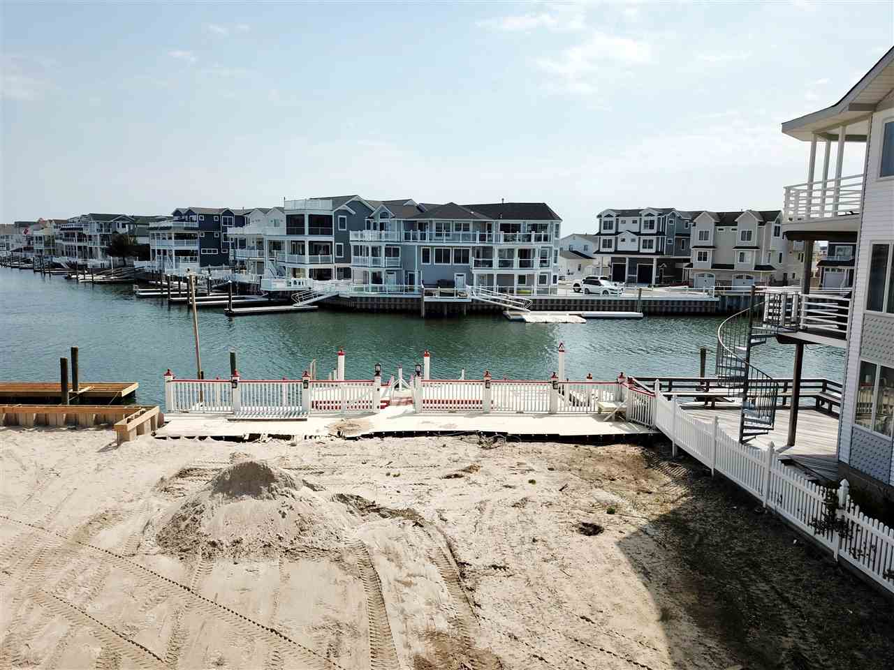 4471 Venicean Road, Unit NORTH Sea Isle City, NJ 08243 - Photo 14 of 14 a view of a lake with a nearby beach