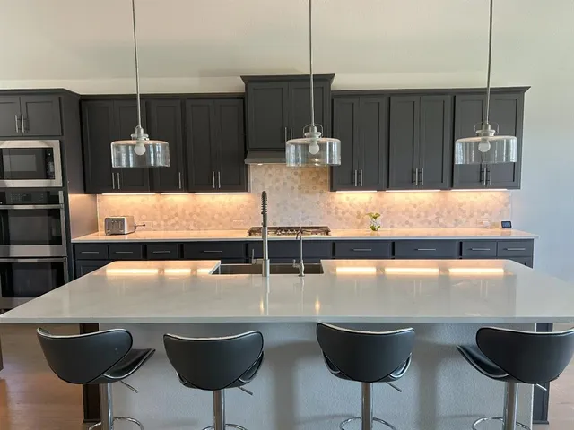 a kitchen with a table chairs and appliances