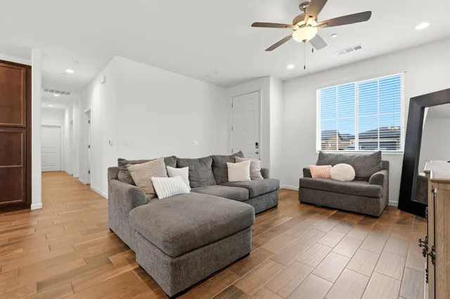 a living room with furniture and kitchen view