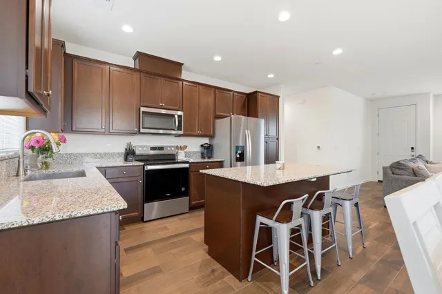 a view of kitchen with cabinets table and chairs