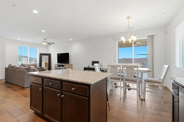 a kitchen with granite countertop wooden cabinets and stainless steel appliances