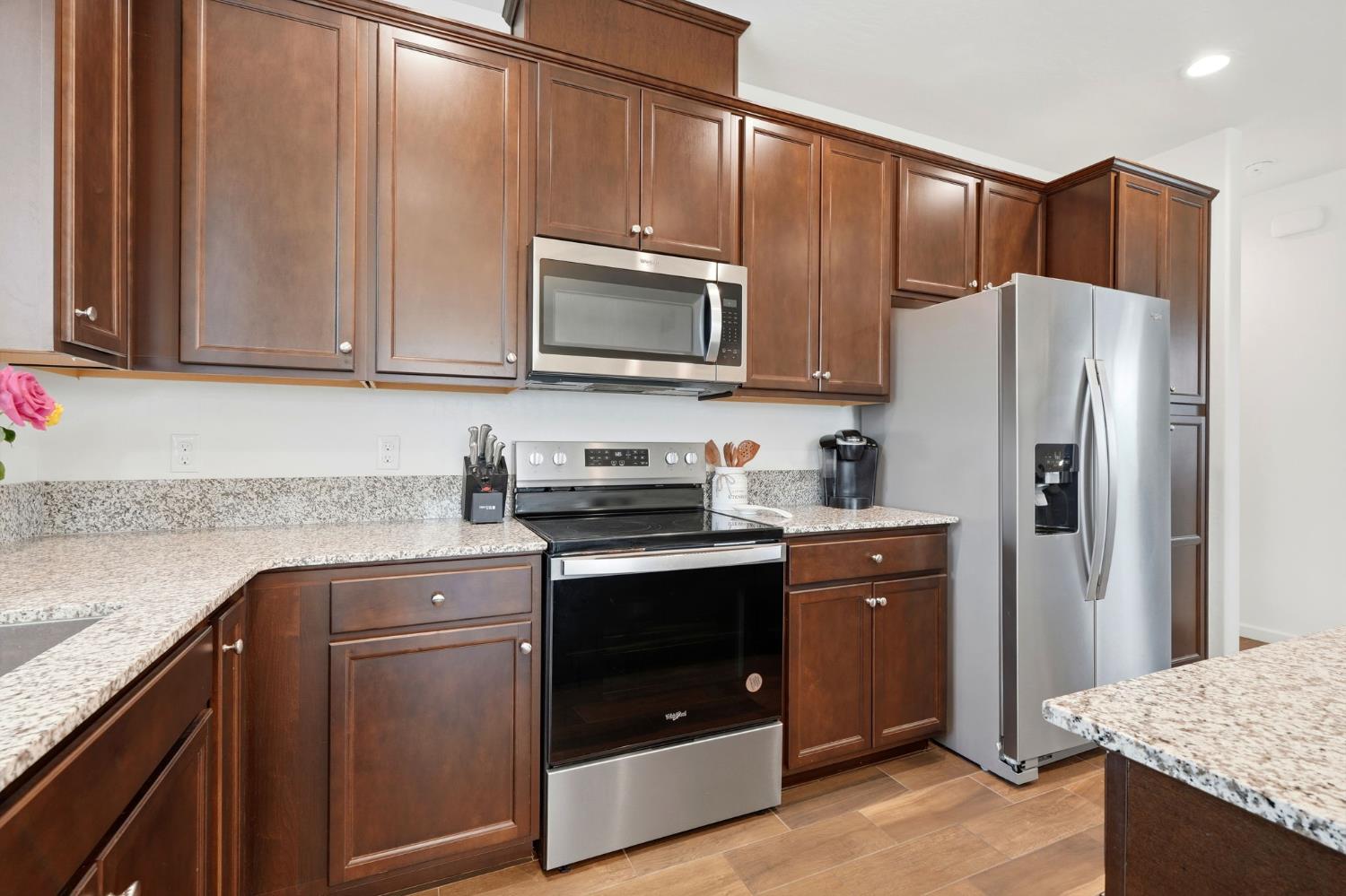 3125 Seymour Street Tulare, CA 93274 - Photo 19 of 52 a kitchen with granite countertop wooden cabinets and stainless steel appliances