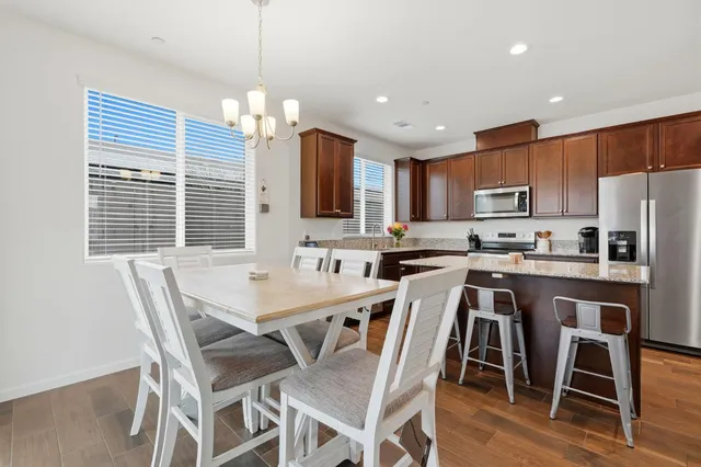 a view of a dining room with furniture and chandelier