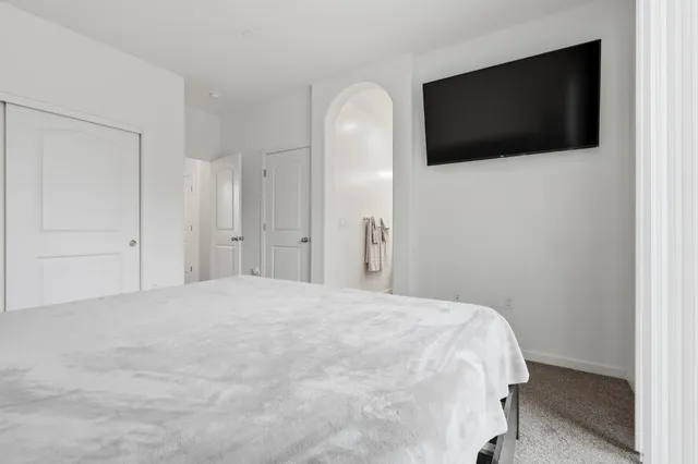 a bedroom with a bed and a television