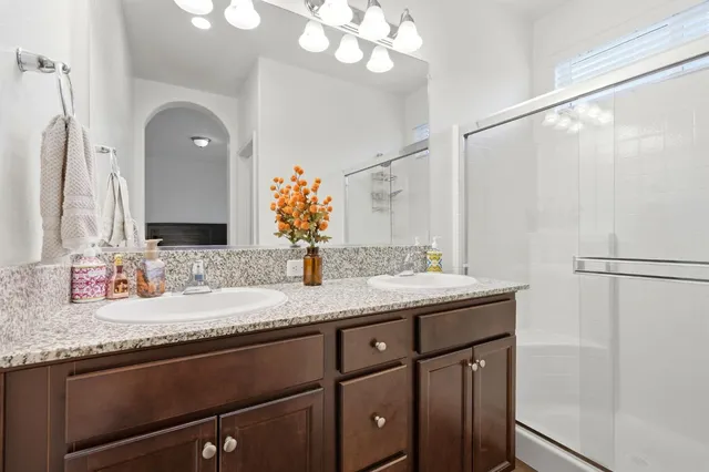 a bathroom with a granite countertop sink a mirror and a vanity