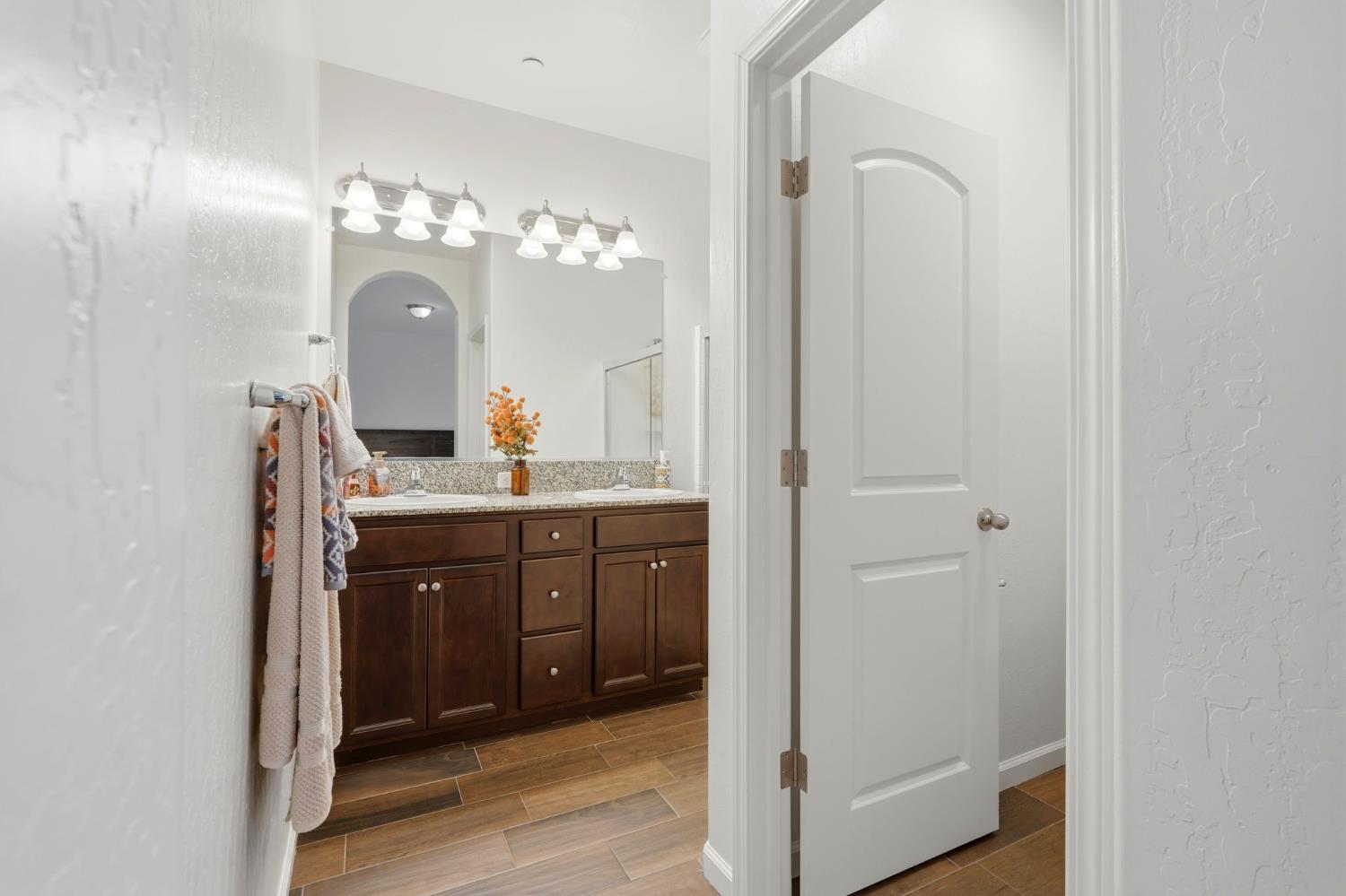 3125 Seymour Street Tulare, CA 93274 - Photo 33 of 52 a bathroom with a granite countertop sink a mirror and a vanity