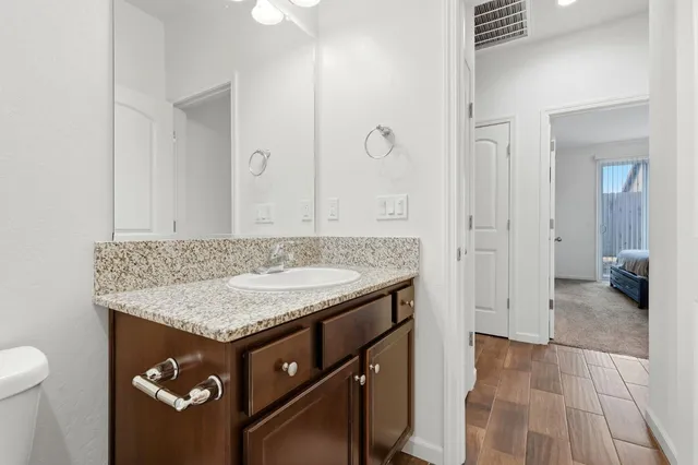 a bathroom with a granite countertop sink toilet and shower