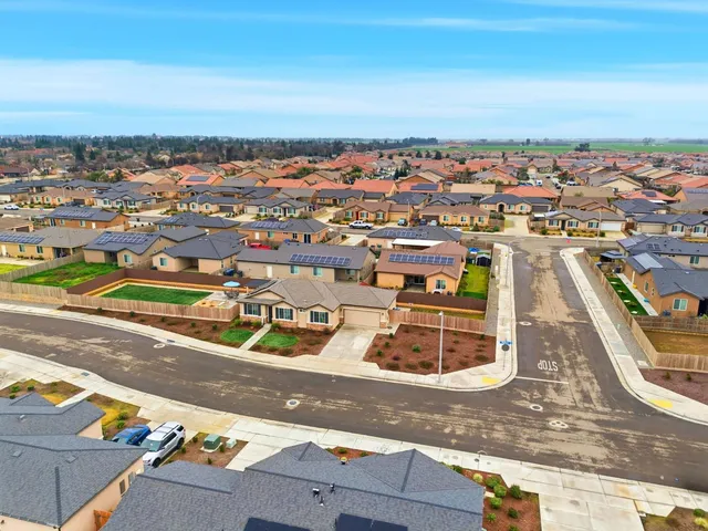 an aerial view of residential houses with city view