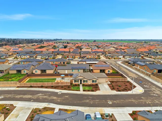 an aerial view of residential houses with city view