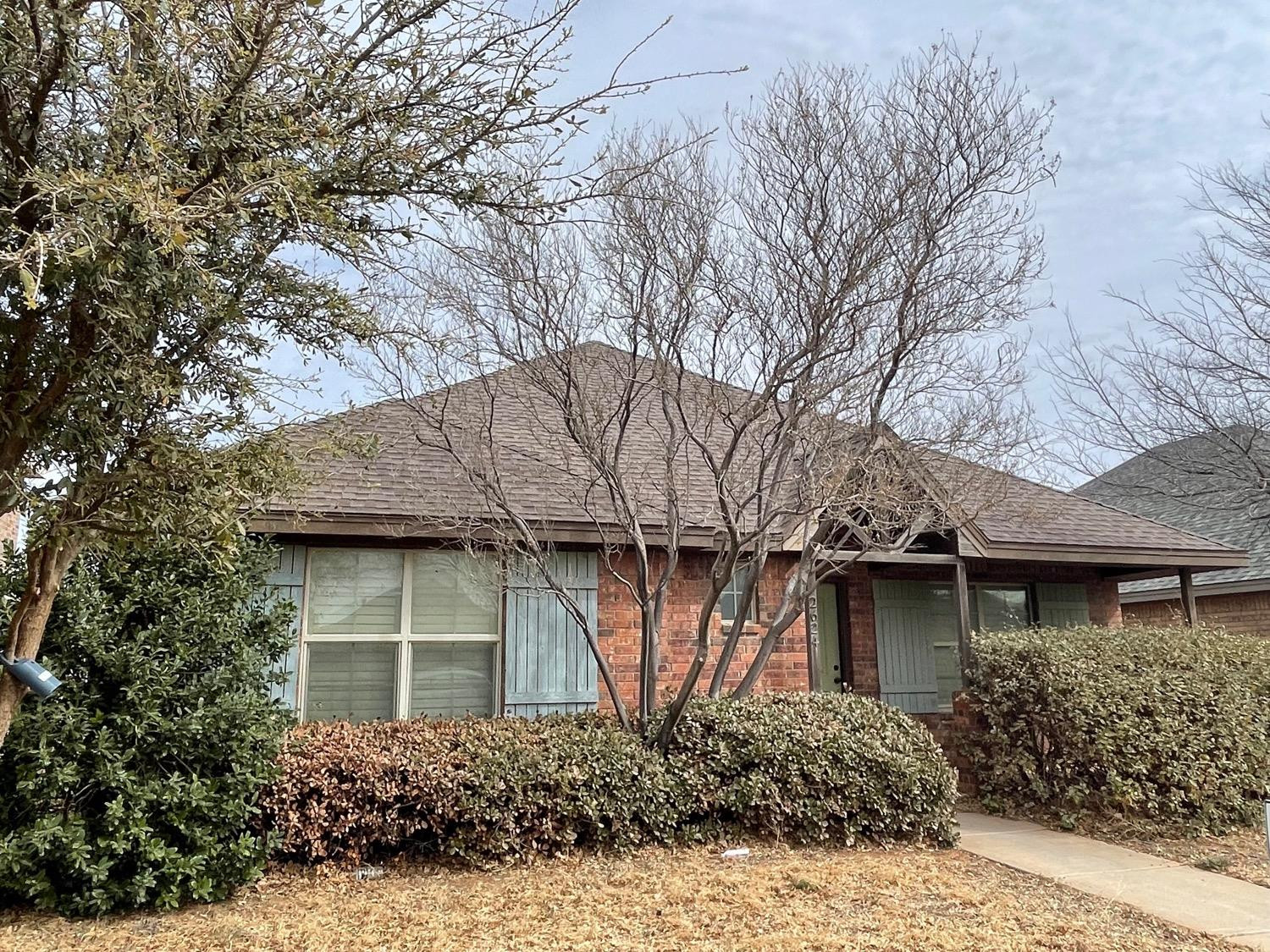 2624 112th Street Lubbock, TX 79423 - Photo 3 of 12 a front view of a house with a garden