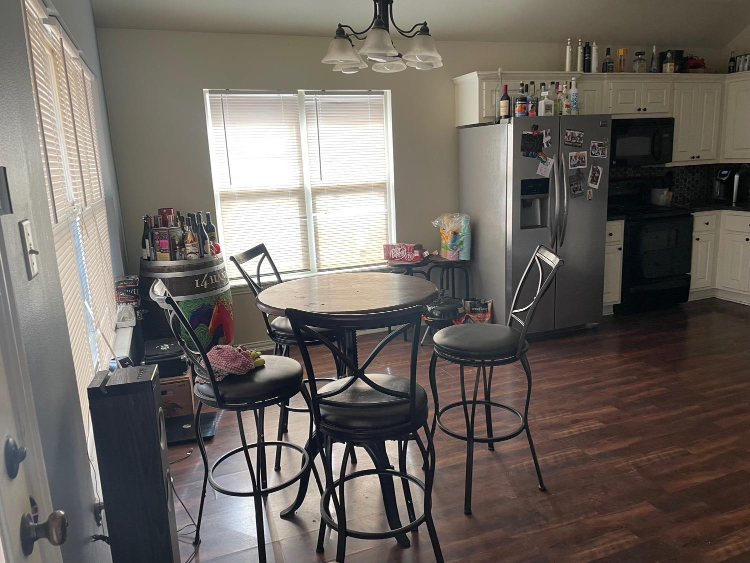 2624 112th Street Lubbock, TX 79423 - Photo 7 of 12 a view of a dining room with furniture and wooden floor