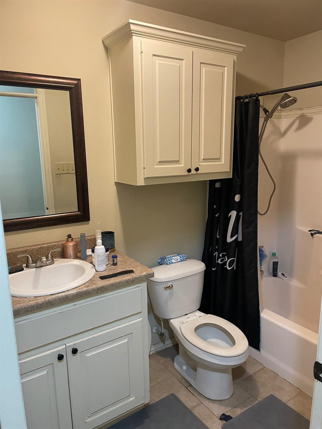 2624 112th Street Lubbock, TX 79423 - Photo 9 of 12 a bathroom with a sink a toilet and a mirror