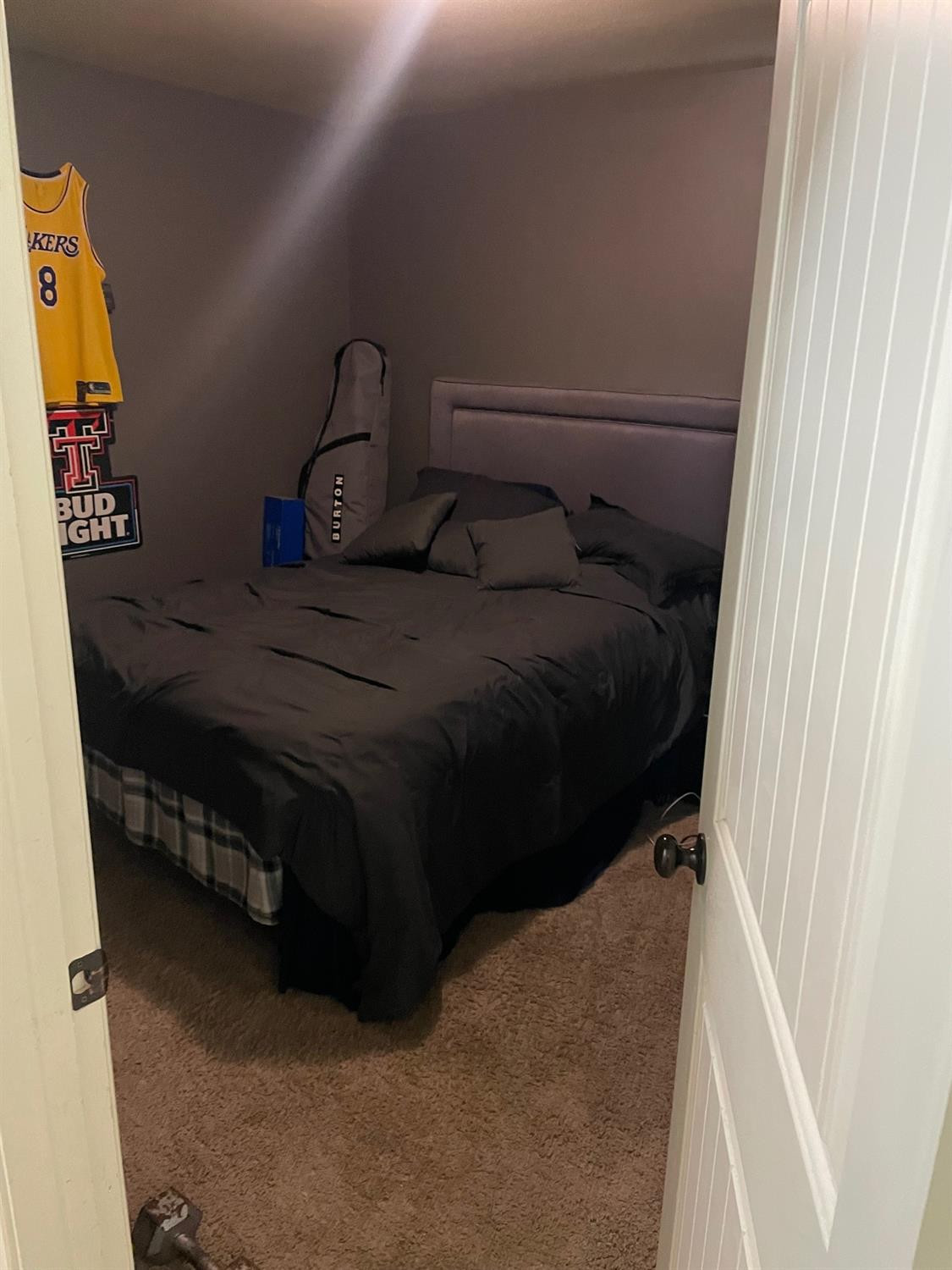 2624 112th Street Lubbock, TX 79423 - Photo 10 of 12 a bed sitting in a bedroom next to a window