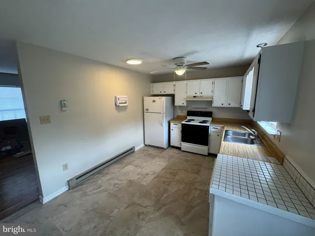 a kitchen with refrigerator and microwave