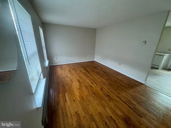 a view of an empty room and wooden floor
