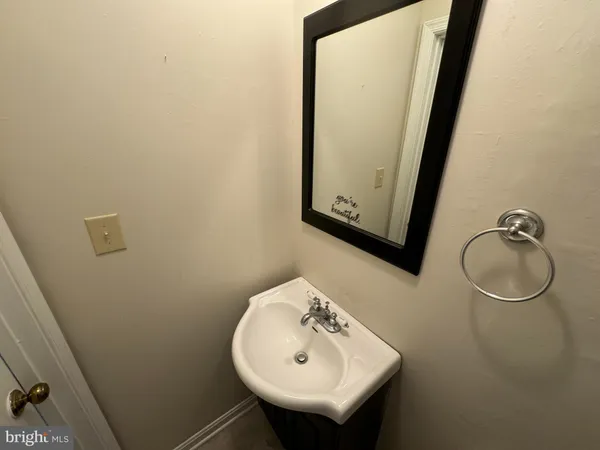 a bathroom with a sink a mirror and vanity