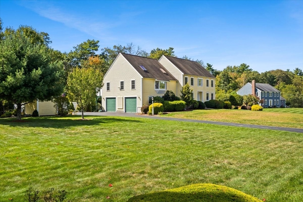 125 Independence Avenue Hanson, MA 02341 - Photo 2 of 42 a house that has a big yard with plants and trees