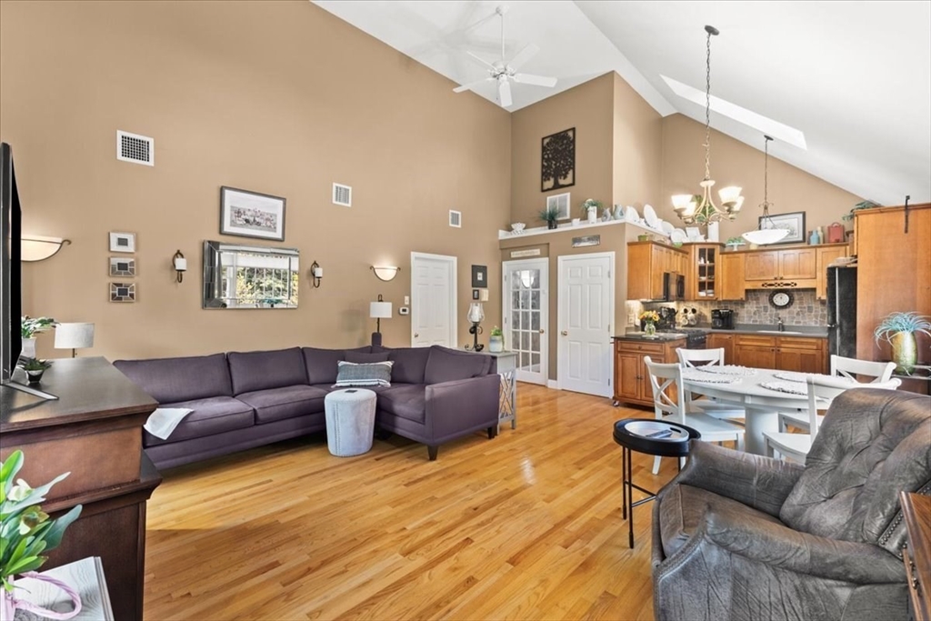 125 Independence Avenue Hanson, MA 02341 - Photo 24 of 42 a living room with furniture kitchen view and a chandelier