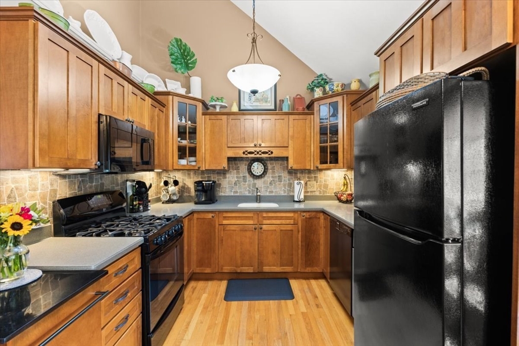 125 Independence Avenue Hanson, MA 02341 - Photo 26 of 42 a kitchen with stainless steel appliances a refrigerator sink stove microwave and cabinets